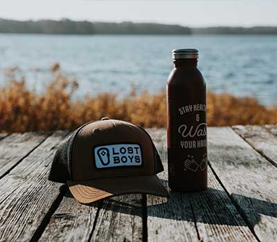 Branded Hat and Thermos on Wooded Dock