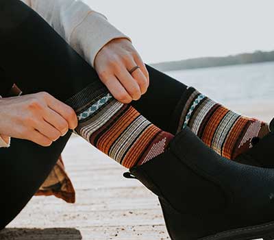 Girl pulling on fancy branded socks